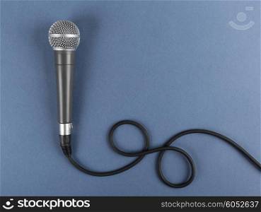 Classic dynamic microphone on a blue background