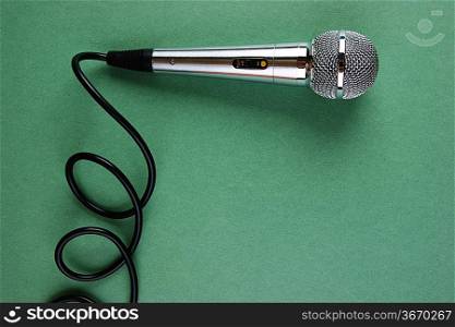 Classic dynamic microphone on a green background