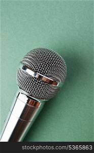 Classic dynamic microphone on a green background