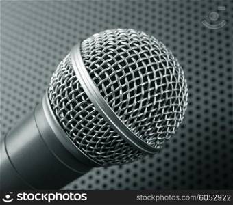 Classic dynamic microphone on black background perforated. Toned
