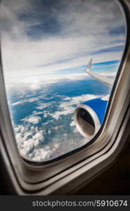 Classic image through aircraft window onto jet engine