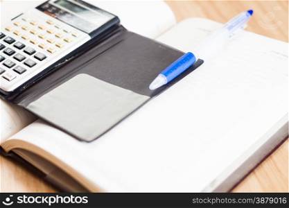 Classic leather notebook with pen and calculator, stock photo
