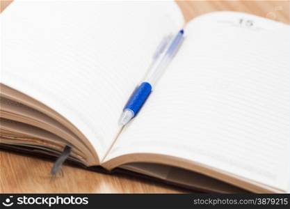 Classic leather notebook with pen, stock photo