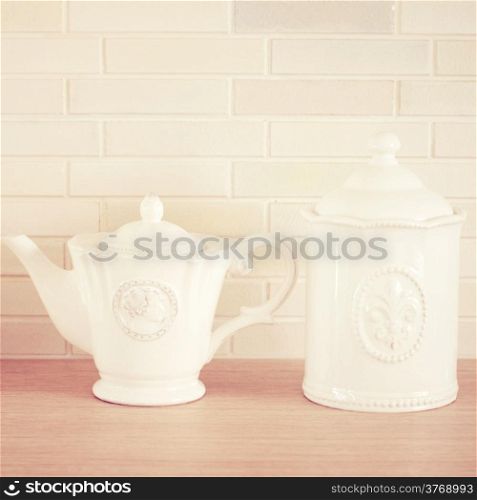 Classic porcelain teapot and jar with retro filter effect
