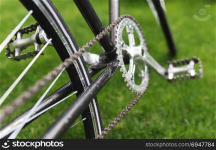 Classic road bicycle close-up photo in the summer green grass meadow field. Travel background. Classic road bicycle close-up photo in the summer green grass meadow field. Travel background.