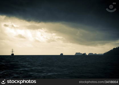 Classic sailing ship in the light of a huge storm