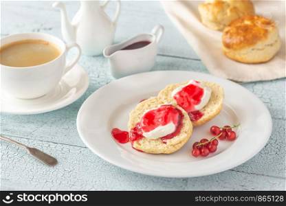 Classic scones with cream and red currant jam