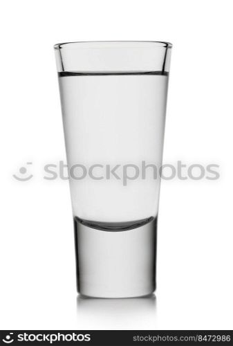 Classic shot glass with tequila or vodka on white.