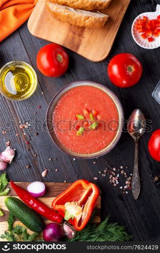 classic spanish raw eating cold soup Gazpacho served at black wooden table. flat lay. food recipe. healthy concept.