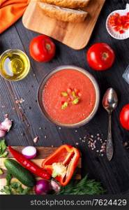classic spanish raw eating cold soup Gazpacho served at black wooden table. flat lay. food recipe. healthy concept.