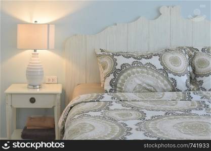 classic style bedding and reading lamp with blue wall