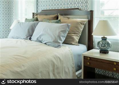 classic style bedroom with blue pillows and chinese lamp style on bedside table