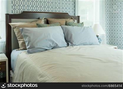 classic style bedroom with blue pillows on bed