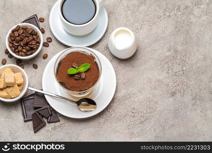 Classic tiramisu dessert in a glass, coffee, chocolate, cream and sugar on concrete background or table. Classic tiramisu dessert in a glass, coffee, chocolate, cream and sugar on concrete background