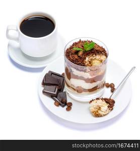 Classic tiramisu dessert in a glass, cup of coffee and pieces of chocolate on white background with clipping path embedded. Classic tiramisu dessert in a glass, cup of coffee and pieces of chocolate on white background with clipping path