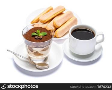 Classic tiramisu dessert in a glass cup, savoiardi cookies and espresso coffee on white background with clipping path embeeded. Classic tiramisu dessert in a glass cup, savoiardi cookies and espresso coffee on white background with clipping path