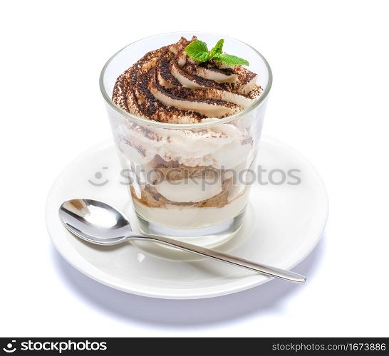 Classic tiramisu dessert in a glass on plate with spoon isolated on a white with clipping path embeeded. Classic tiramisu dessert in a glass on plate with spoon isolated on a white with clipping path