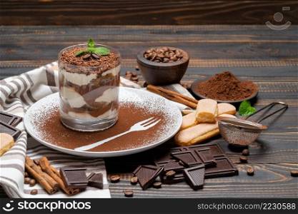 Classic tiramisu dessert in a glass on wooden background or table. Classic tiramisu dessert in a glass on wooden background