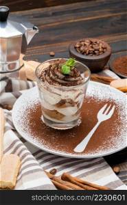 Classic tiramisu dessert in a glass on wooden background or table. Classic tiramisu dessert in a glass on wooden background