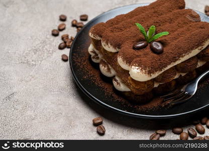 Classic tiramisu dessert on ceramic plate on concrete background or table. Classic tiramisu dessert on ceramic plate on concrete background