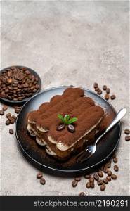 Classic tiramisu dessert on ceramic plate on concrete background or table. Classic tiramisu dessert on ceramic plate on concrete background