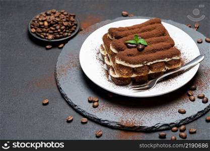 Classic tiramisu dessert on ceramic plate on concrete background or table. Classic tiramisu dessert on ceramic plate on concrete background