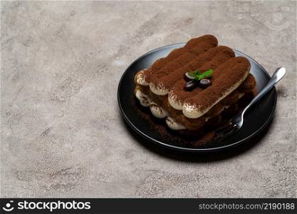 Classic tiramisu dessert on ceramic plate on light grey concrete background or table. Classic tiramisu dessert on ceramic plate on light grey concrete background