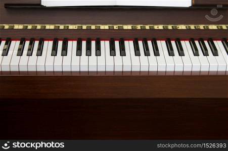 Classic upright piano keyboard black and white front view. Piano keyboard front