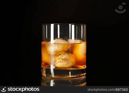 Classic whiskey highball on the black background, copy space Whiskey