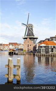 Classic windmill at canal in The Netherlands