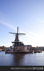 Classic windmill at canal in The Netherlands