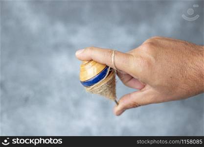 Classic wooden spinning top toy with string