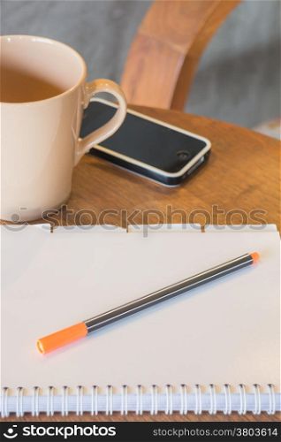 Classic wooden work station with smart phone, stock photo