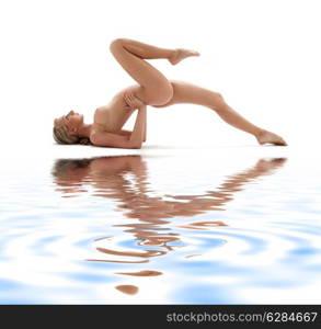 classical artistic nudity style picture of woman working out on white sand