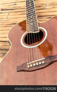 Classical guitar on wood background. Music and entertainment concept.