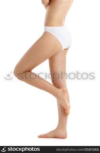 classical picture of legs and torso in white bikini panties