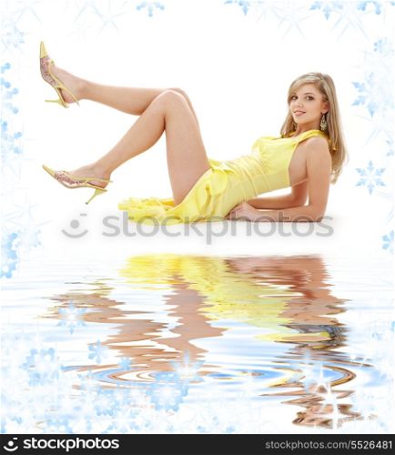 classical pin-up image of pretty lady in yellow dress on white sand