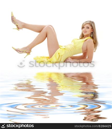 classical pin-up image of pretty lady in yellow dress on white sand