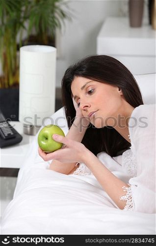 classy brunette beholding green apple