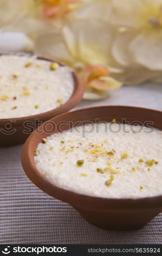 Clay bowls of phirni on table