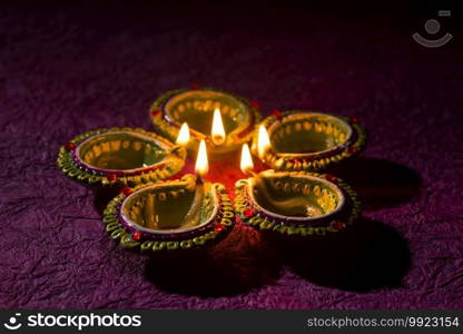 Clay diya l&s lit during Diwali Celebration. Greetings Card Design Indian Hindu Light Festival called Diwali