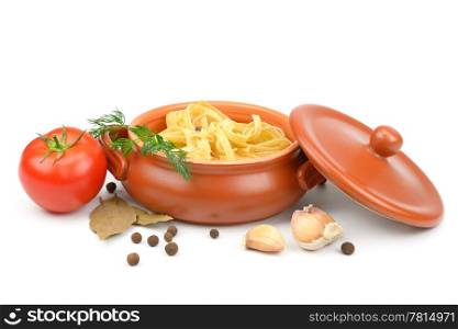 Clay pot with pasta, vegetables and spices isolated on white background.
