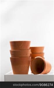 Clay pots on white wooden table.