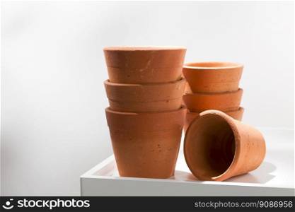 Clay pots on white wooden table.