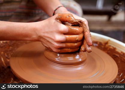 clay potter hands closeup working on wheel handcrafts pottery work