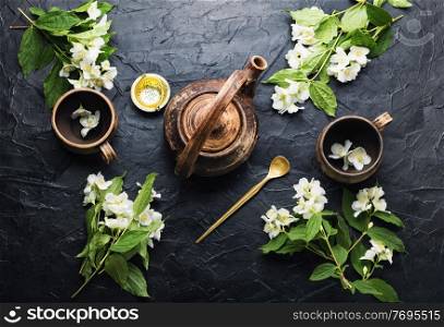 Clay tea cups and teapot.Jasmine flower tea herbal tea.Herbal medicine.. Jasmine flower tea