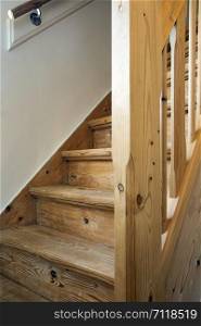 Clean and new wooden staircase in modern home interior close-up brown. Clean and new wooden staircase in modern home interior close-up