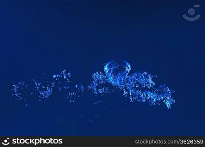 Clean blue water splash on dark blue background