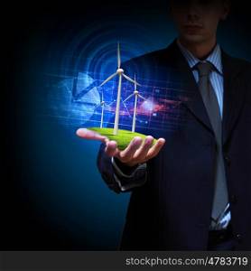 clean energy. windmills. Business man and a windmills as a symbol of green energy