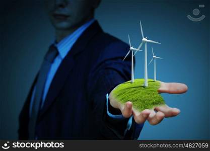 clean energy. windmills. Business man and a windmills as a symbol of green energy